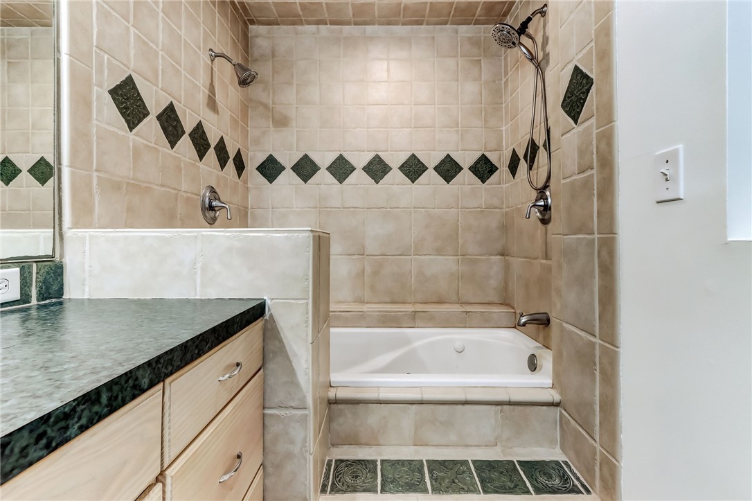 96242 Lang Road Yulee, FL 32097 - Photo 19 of 32 a bathroom with a granite countertop sink and a bathtub