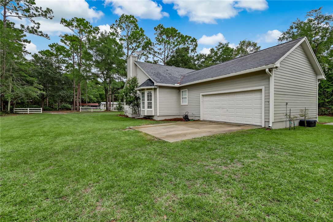 96242 Lang Road Yulee, FL 32097 - Photo 26 of 32 a view of a backyard with a garden