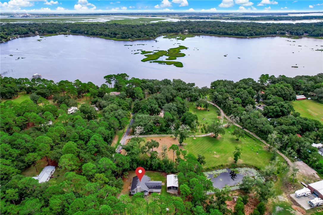 96242 Lang Road Yulee, FL 32097 - Photo 30 of 32 an aerial view of a house with a yard and lake view