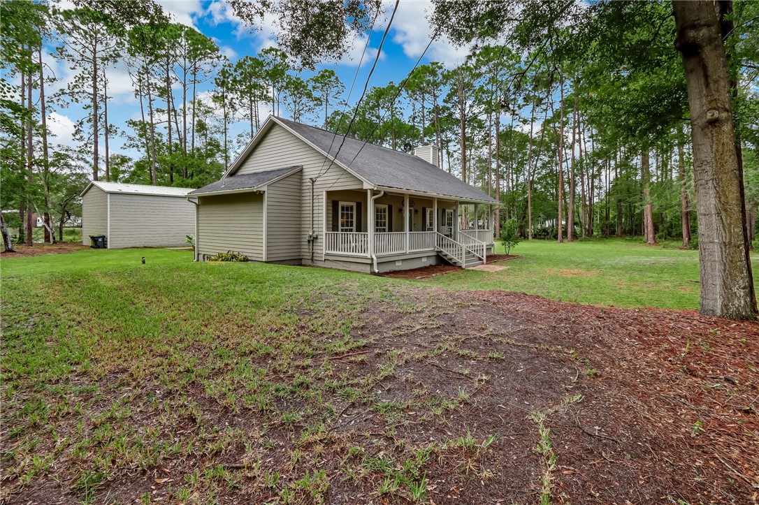 96242 Lang Road Yulee, FL 32097 - Photo 3 of 32 a view of a house with a yard and large trees