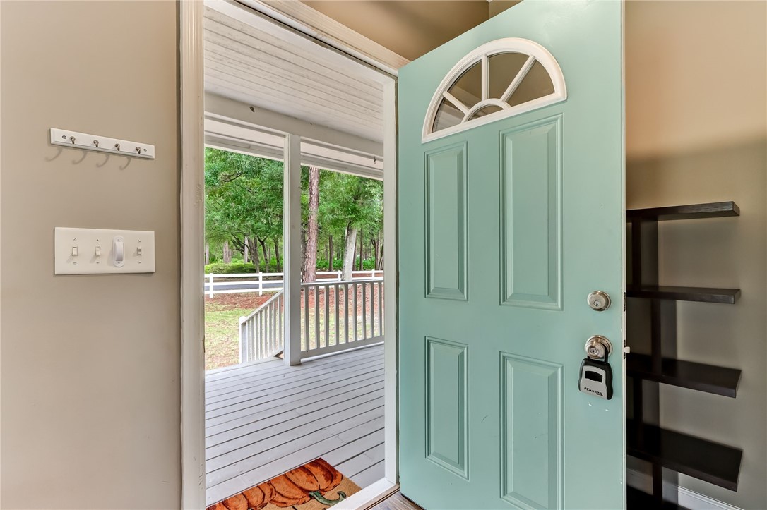96242 Lang Road Yulee, FL 32097 - Photo 8 of 32 a view of a hallway with wooden floor and windows
