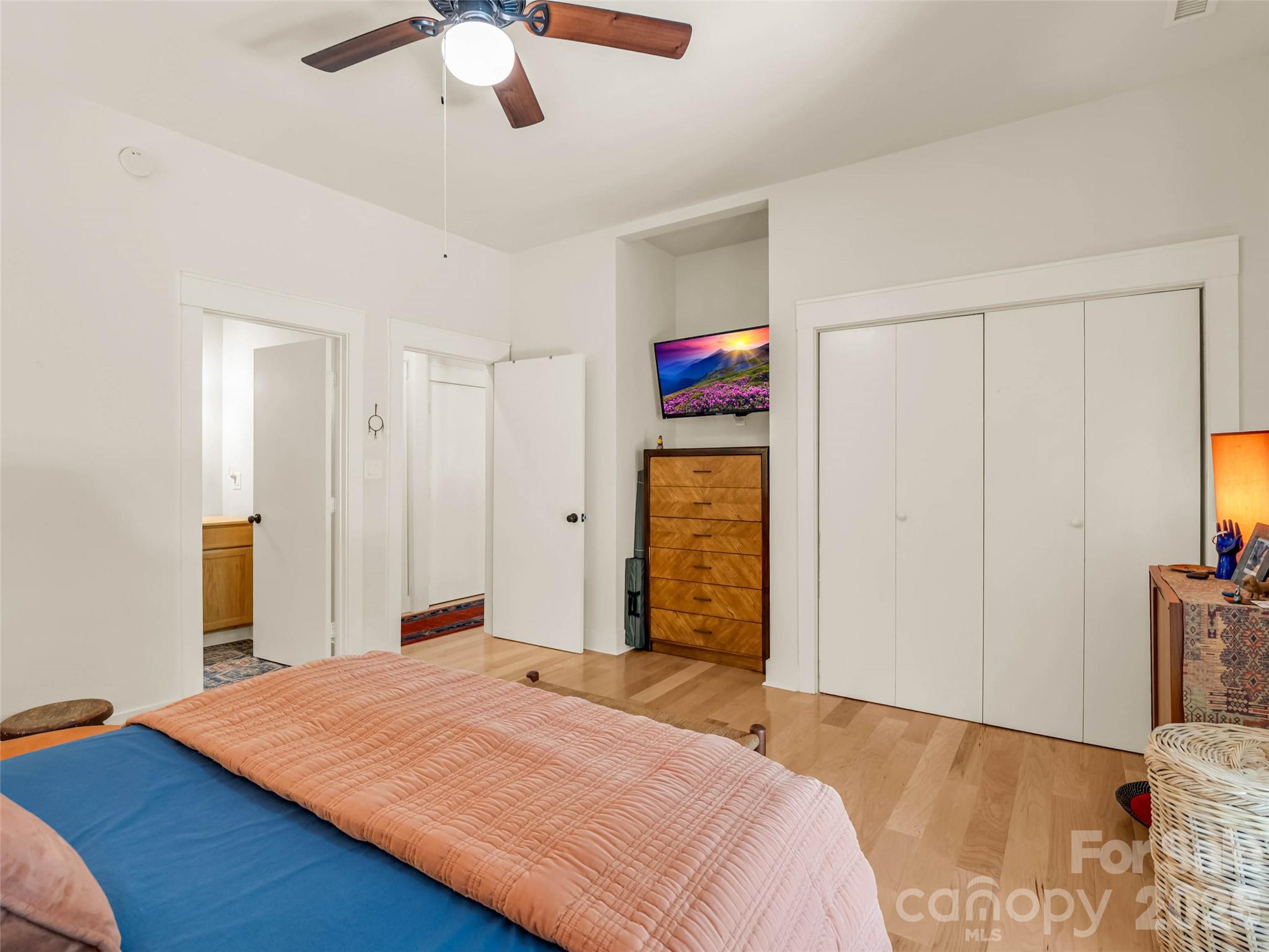 120 Glenn Court Mill Spring, NC 28756 - Photo 35 of 48 a bedroom with a bed and a chandelier