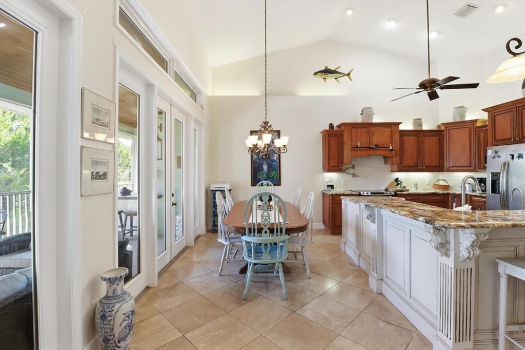5 Palm Drive Yankeetown, FL 34498 - Photo 12 of 53 a very nice looking kitchen with a dining table chairs and a wooden floor