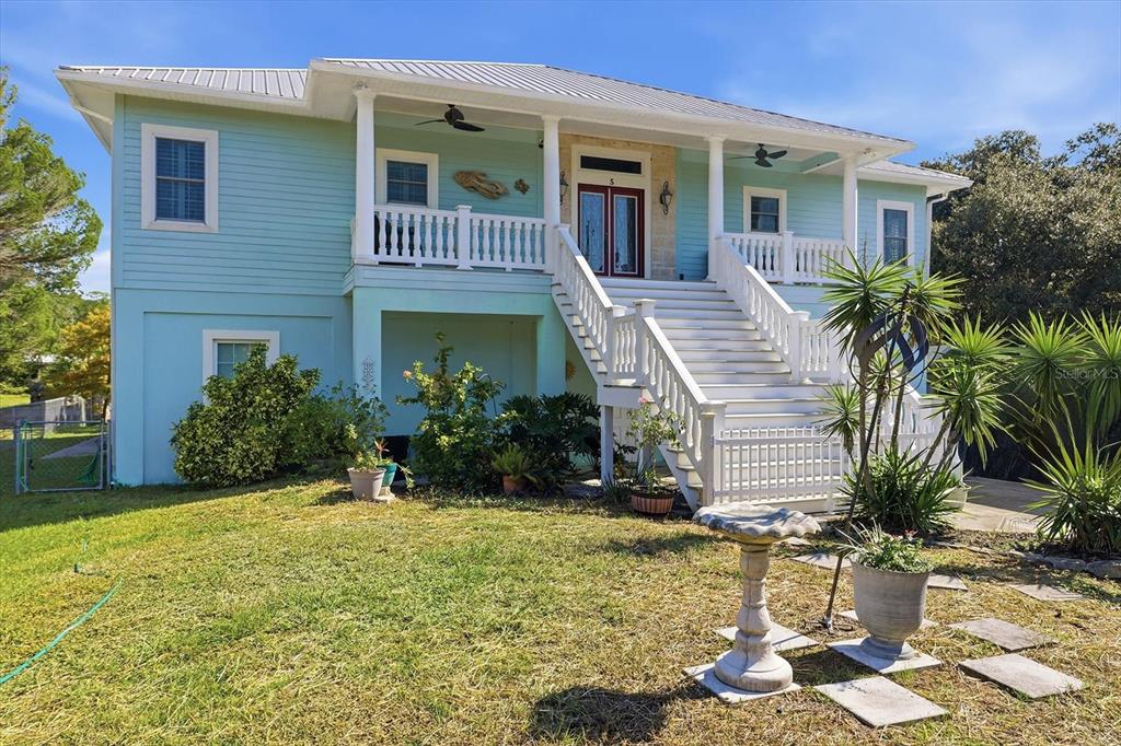 5 Palm Drive Yankeetown, FL 34498 - Photo 2 of 53 a front view of a house with a yard