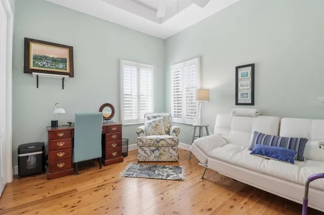 a bedroom with a bed table and window