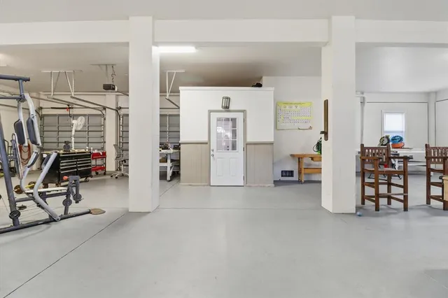 a view of a room with lots of white furniture