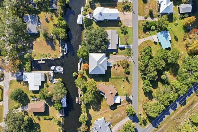 an aerial view of a houses with a yard