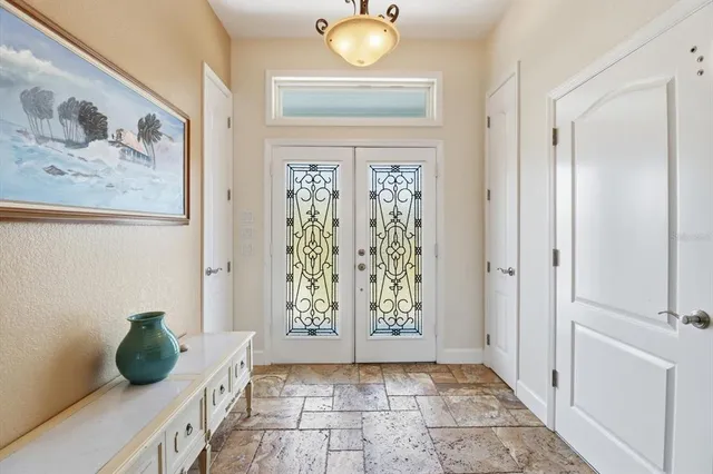 a living room with furniture a fireplace and a chandelier