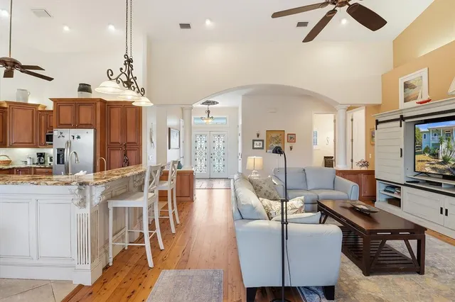 a living room with furniture and a chandelier