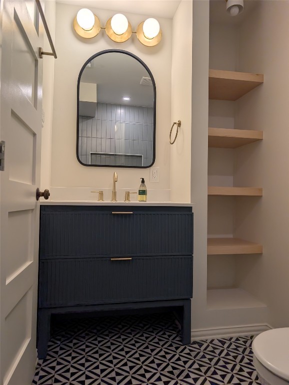 1210 Windsor Road, Unit 117 Austin, TX 78703 - Photo 13 of 17 a bathroom with a sink a toilet and a mirror