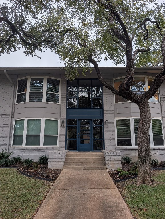 1210 Windsor Road, Unit 117 Austin, TX 78703 - Photo 16 of 17 a front view of a house with a tree in front