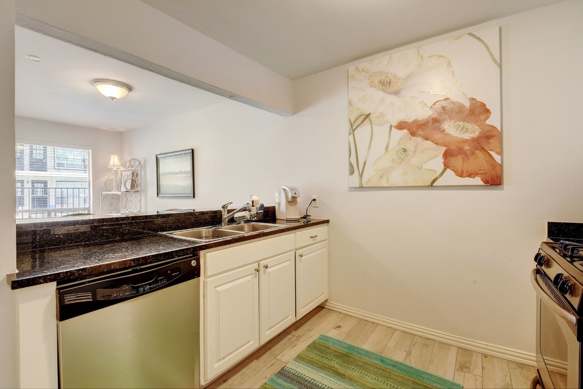 1210 Windsor Road, Unit 117 Austin, TX 78703 - Photo 6 of 17 a kitchen with a sink and cabinets