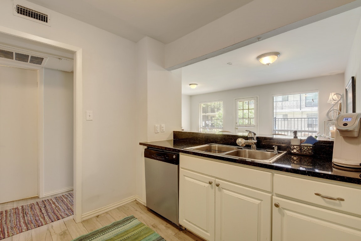 1210 Windsor Road, Unit 117 Austin, TX 78703 - Photo 7 of 17 a kitchen with a sink and cabinets