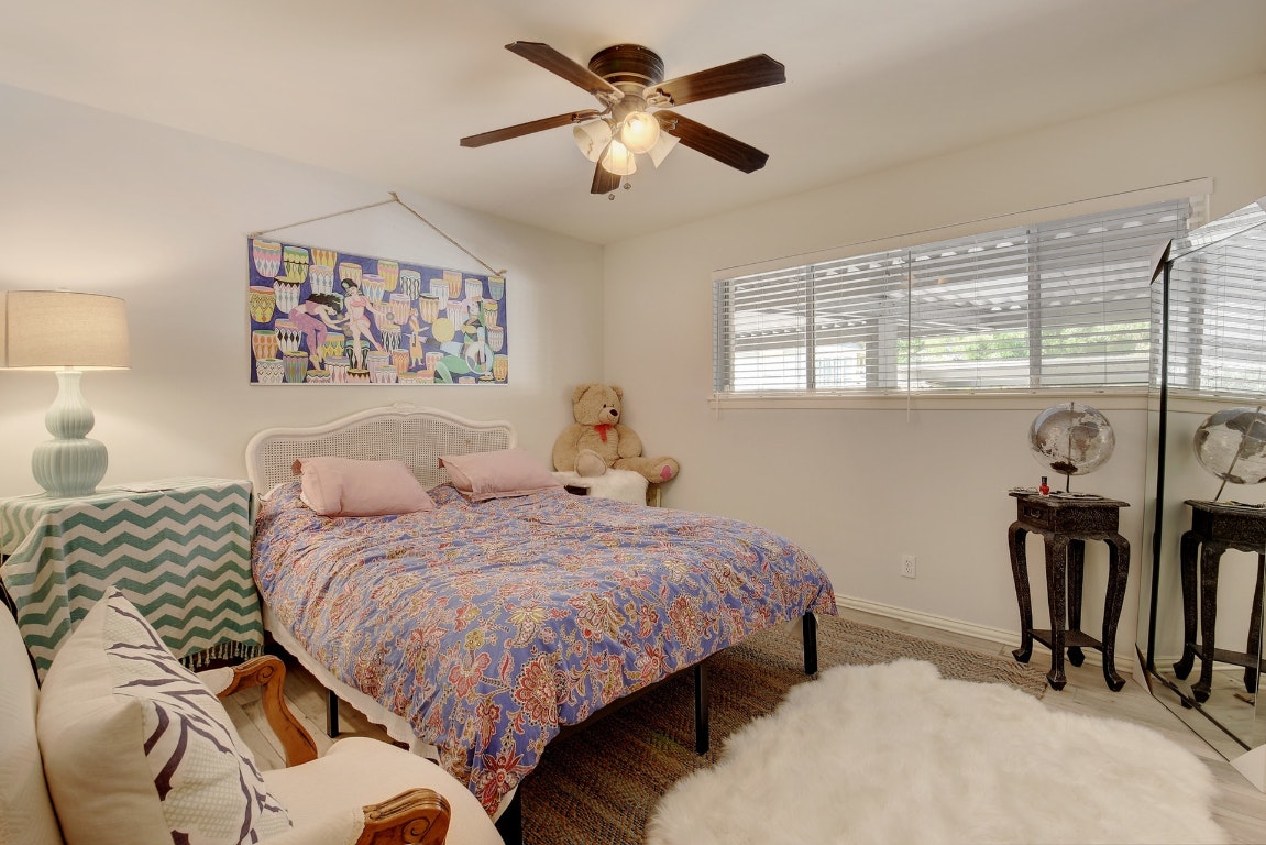 1210 Windsor Road, Unit 117 Austin, TX 78703 - Photo 10 of 17 a bedroom with two bed and a large mirror