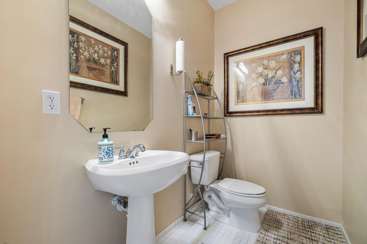 669 Northwest 38th Circle Boca Raton, FL 33431 - Photo 15 of 35 a bathroom with a toilet a sink and mirror