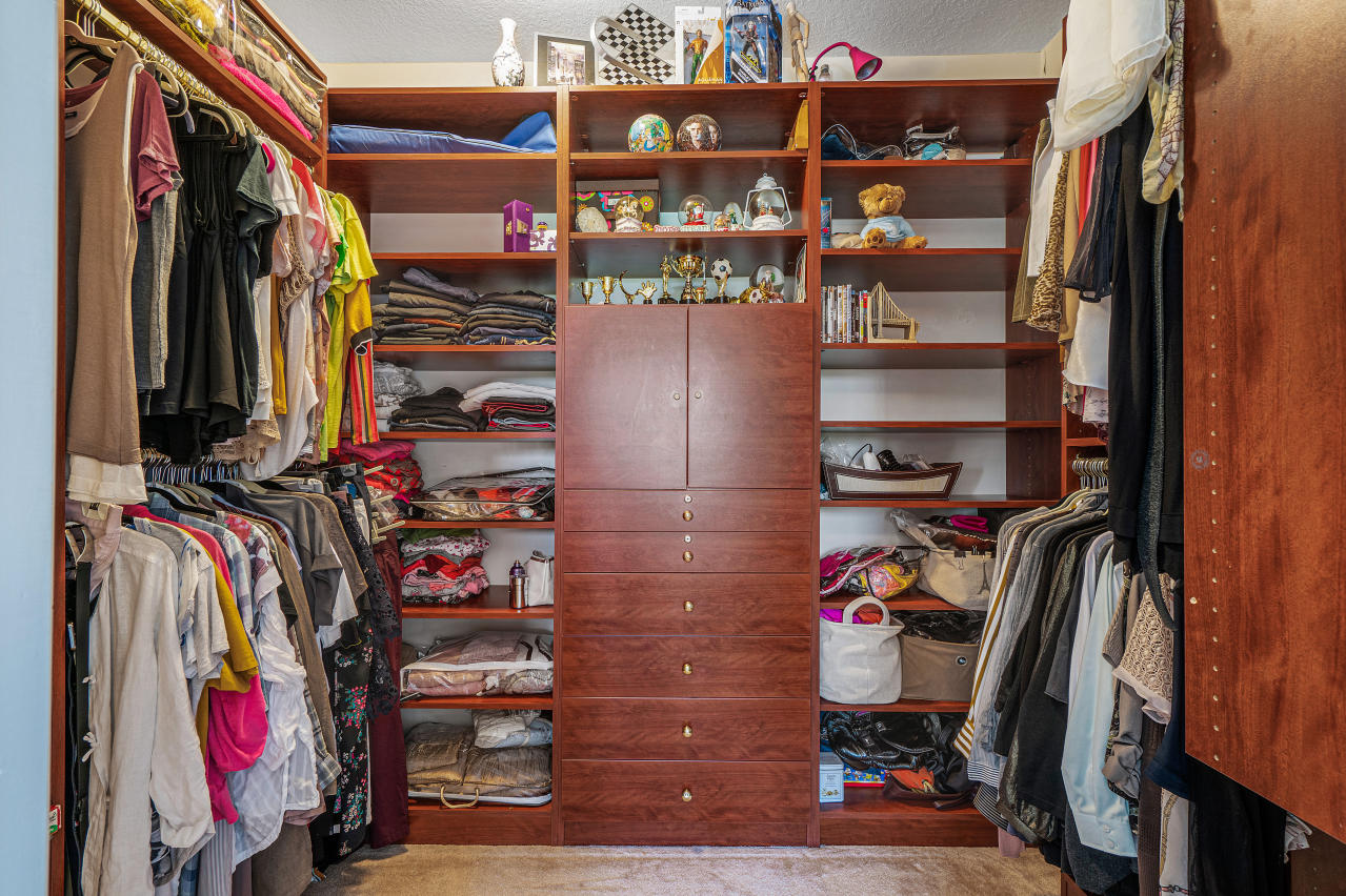 669 Northwest 38th Circle Boca Raton, FL 33431 - Photo 26 of 35 a view of walk in closet with clothes and shoes