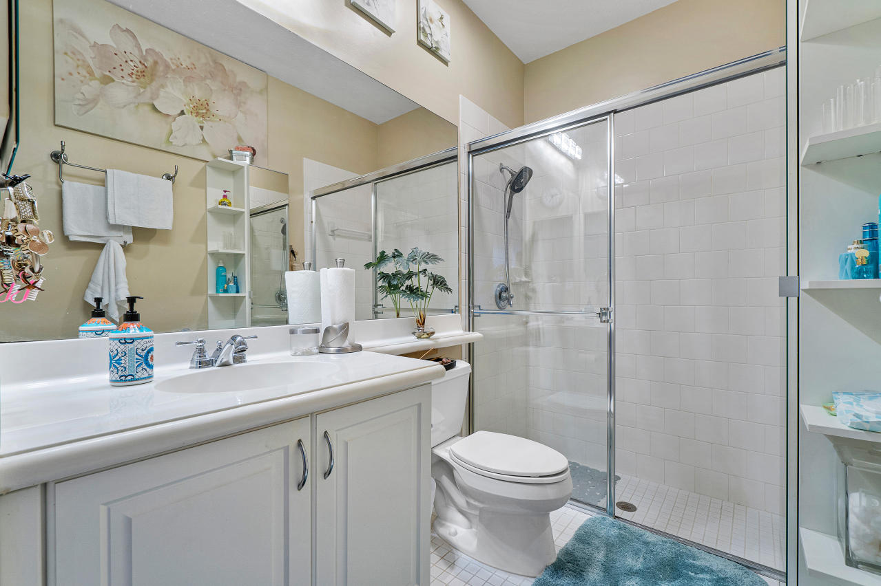 669 Northwest 38th Circle Boca Raton, FL 33431 - Photo 7 of 35 a bathroom with a sink and mirror with toilet