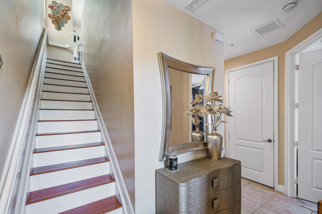 669 Northwest 38th Circle Boca Raton, FL 33431 - Photo 8 of 35 a view of a hallway with wooden floor and staircase