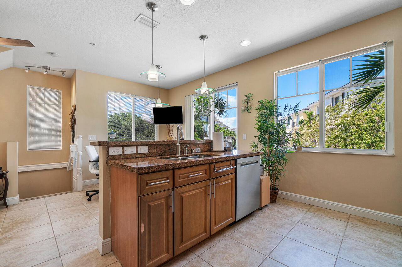 669 Northwest 38th Circle Boca Raton, FL 33431 - Photo 9 of 35 a kitchen with kitchen island granite countertop a sink and a stove