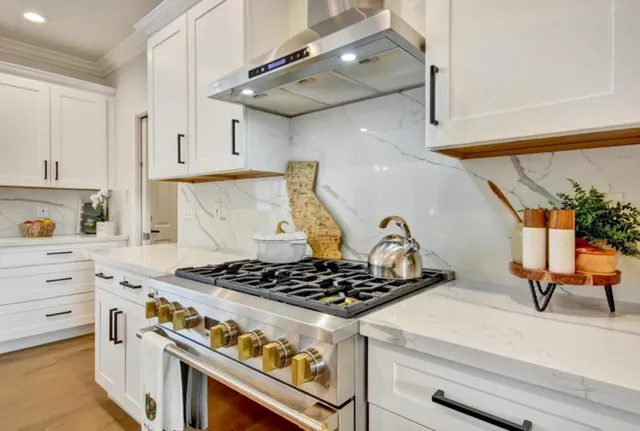 a white stove top oven sitting inside of a kitchen