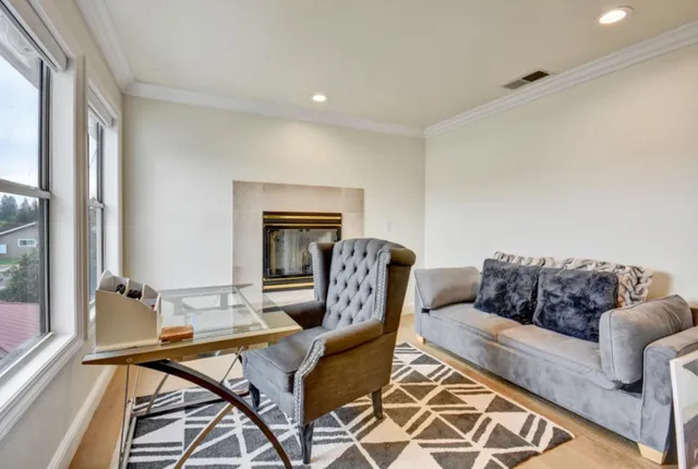 a living room with furniture and a fireplace