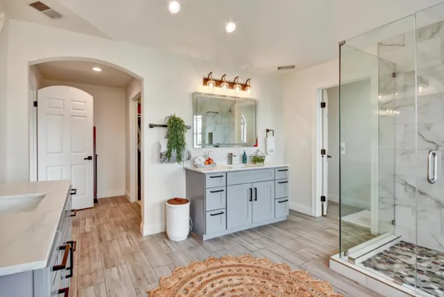 a bathroom with a sink a toilet and shower