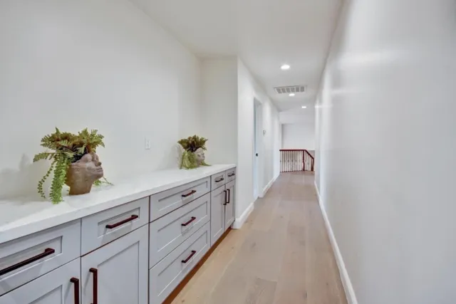 a hallway with view of wooden floor