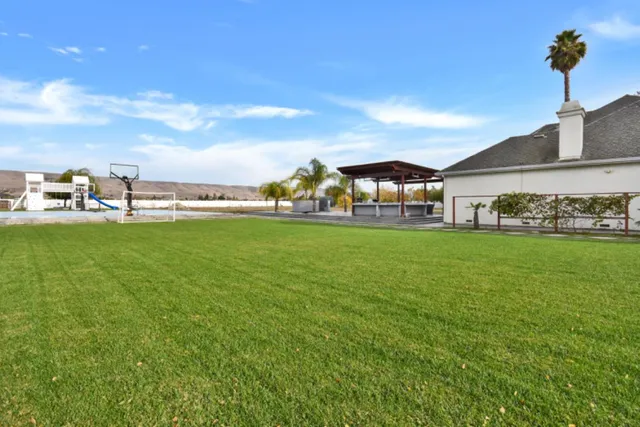 a white house that has a tree in front of it
