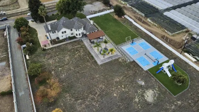 swimming pool view with plants and large trees