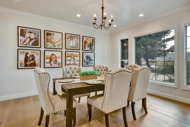 a dining room with furniture a livingroom view and wooden floor