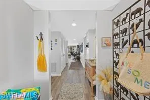 a view of a hallway with paintings on the wall