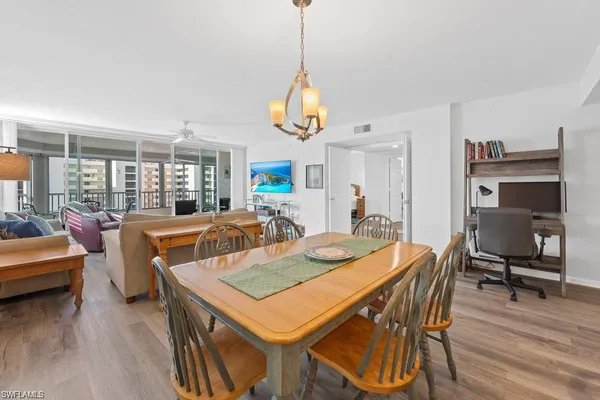 a dining room with furniture and wooden floor