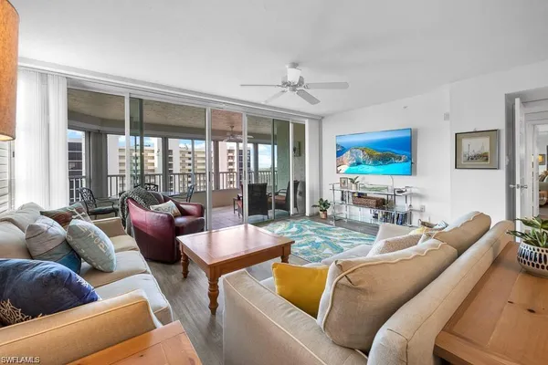 a living room with furniture fireplace and flat screen tv