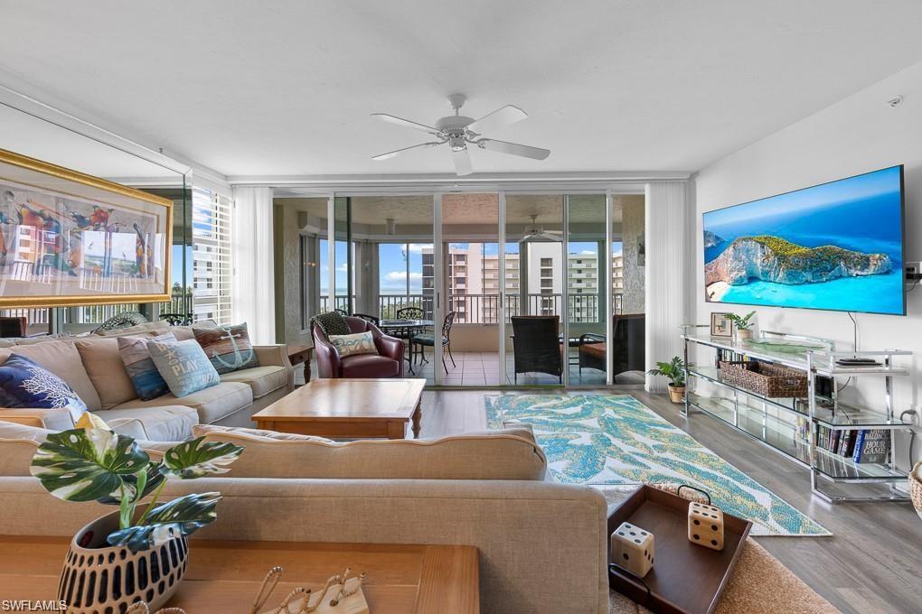 21 Bluebill Avenue, Unit B905 Naples, FL 34108 - Photo 22 of 34 a living room with furniture fireplace and flat screen tv