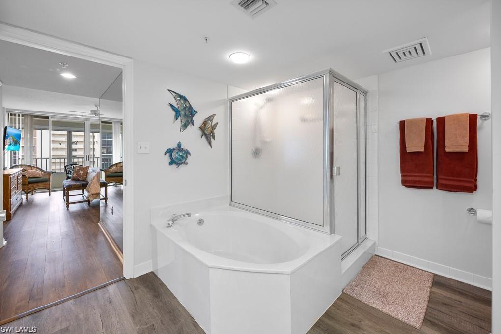 21 Bluebill Avenue, Unit B905 Naples, FL 34108 - Photo 29 of 34 a bathroom with a bathtub and a shower