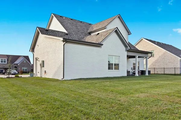 a view of a house with a yard and garage