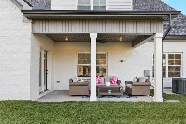 a view of a patio with chair and tables