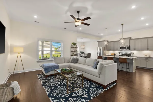 a living room with furniture and a wooden floor
