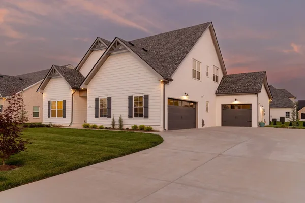 a view of a house with a yard and garage