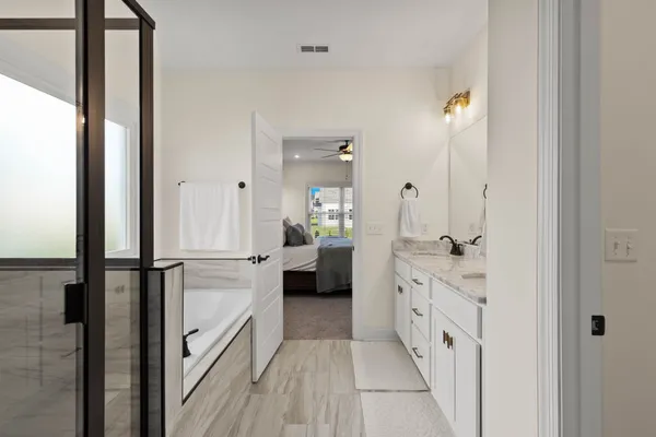 a bathroom with a double vanity sink and mirror
