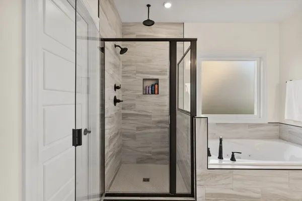 a bathroom with a shower and a tub