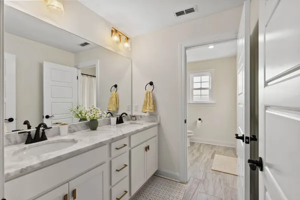 a spacious bathroom with a double vanity sink mirror and