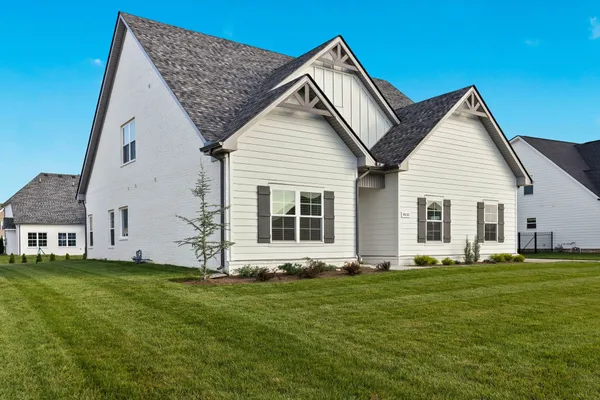 a front view of house with yard and green space