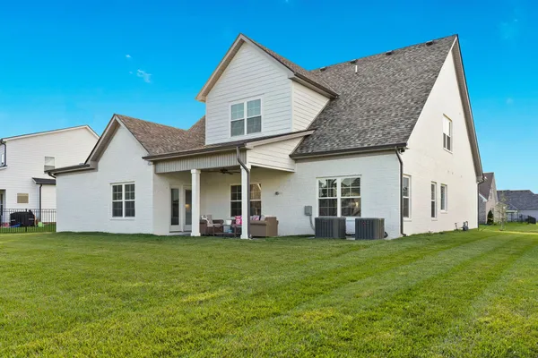 a front view of house with yard and green space