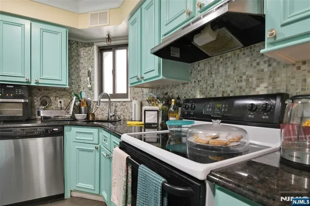 a kitchen with a sink a stove and cabinets