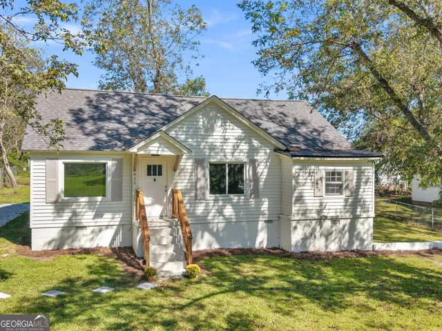 a view of a house with backyard porch and sitting area
