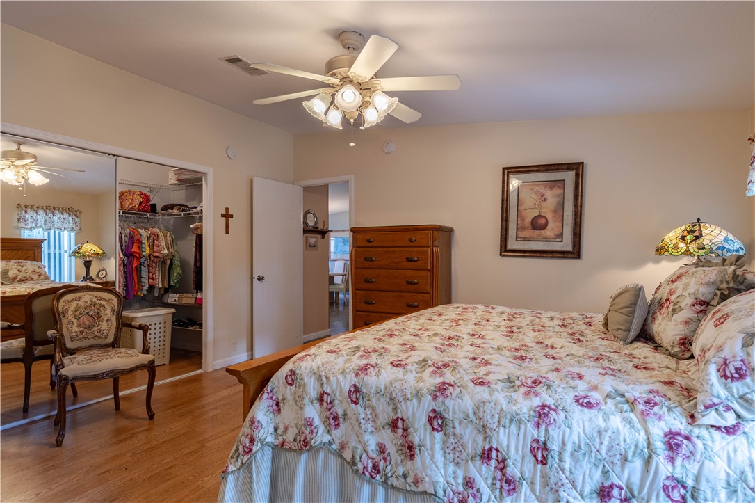 327 Papaya Circle Sebastian, FL 32976 - Photo 13 of 32 a bedroom with a bed and wooden floor
