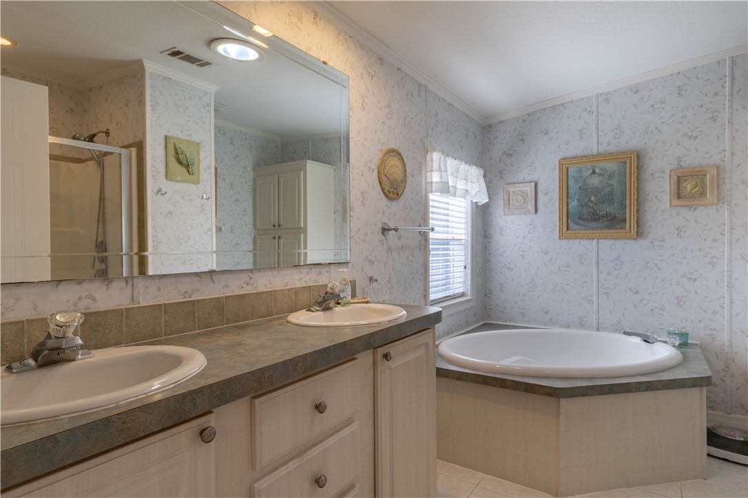327 Papaya Circle Sebastian, FL 32976 - Photo 14 of 32 a bathroom with a double vanity sink and a mirror