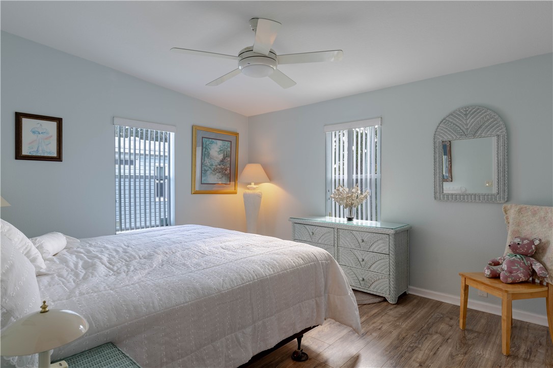 327 Papaya Circle Sebastian, FL 32976 - Photo 16 of 32 a bedroom with a bed and a dresser next to a window