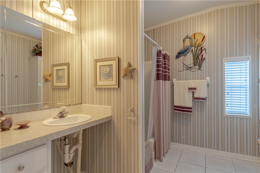 327 Papaya Circle Sebastian, FL 32976 - Photo 19 of 32 a bathroom with a sink and mirror